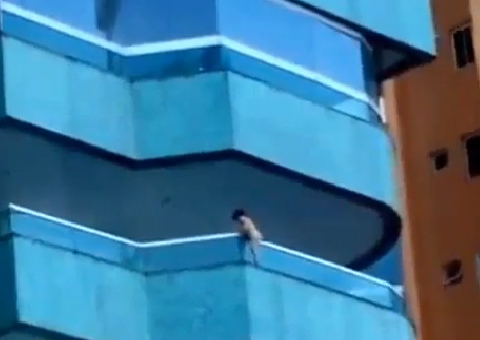 Criança fica pendurada em parapeito de prédio enquanto mãe dormia
