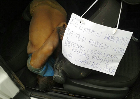 Bandidos deixam cartaz irônico junto à vítima morta a tiros dentro de Strada