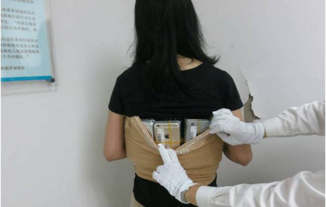 Mulher é detida após ser flagrada com mais de 100 iPhones presos ao corpo