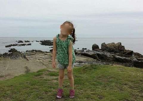 Casal tira foto de filha em passeio e detalhe atrás da criança chama atenção