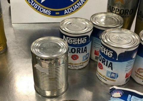 Com cocaína líquida escondida em latas de creme de leite, homem é preso em aeroporto