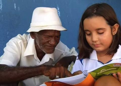 Criança ajuda a 'alfabetizar' vendedor de picolé que trabalha há 40 anos em escola