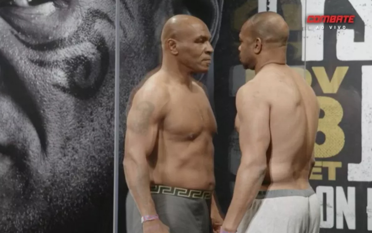 Myke Tyson e Roy Jones se encaram separados por parede de acrílico