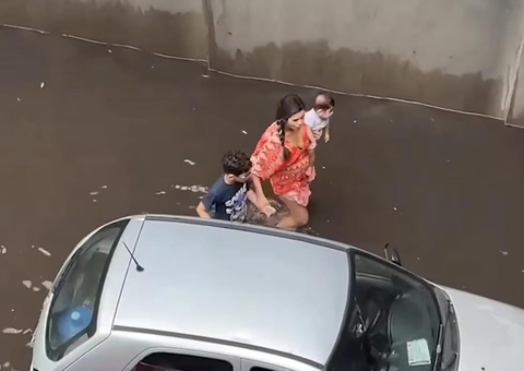 Mãe com bebê no colo tenta empurrar carro após temporal em Manaus; vídeo