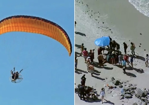 Filho morre e pai fica ferido após queda de paramotor no mar 