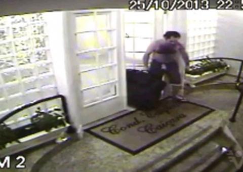 Em imagens de vídeo, filho leva mala com corpo da mãe